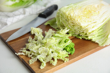 Chopped Chinese cabbage on wooden board, closeup