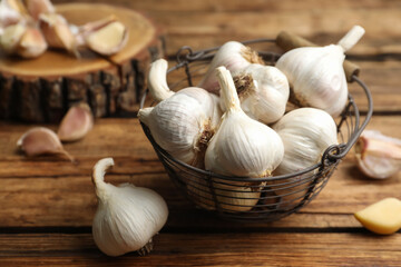 Fresh organic garlic in basket on wooden table