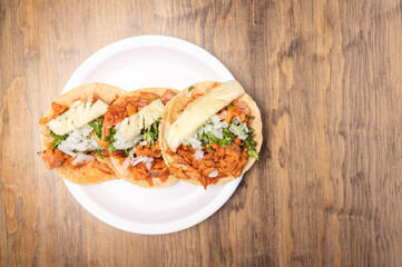 Pastor tacos with corn tortillas. Mexican food. Mexican food concept on wooden table. Traditional mexican food.