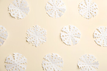 Many paper snowflakes on light background, flat lay
