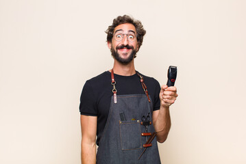 young man looking happy and goofy with a broad, fun, loony smile and eyes wide open