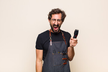young man shouting aggressively, looking very angry, frustrated, outraged or annoyed, screaming no
