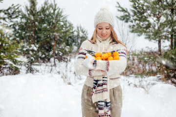 girl with tangerines in the winter forest