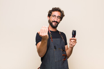 young man feeling happy, successful and confident, facing a challenge and saying bring it on! or welcoming you