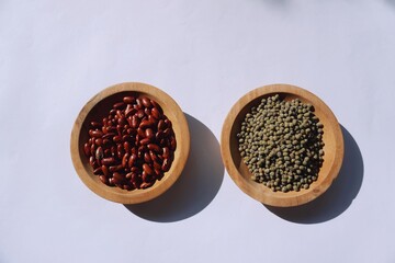 Vigna angularis and Vigna radiata in a wooden plate isolated on a white background.
