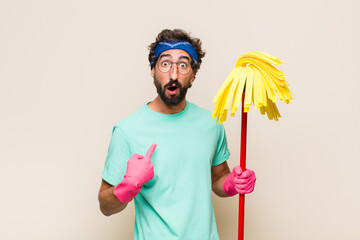 young man looking shocked and surprised with mouth wide open, pointing to self