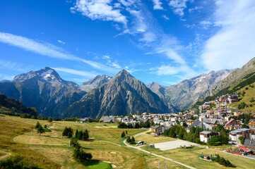 Landscape with view on ski station Les deux Alpes and Alpine mountains peaks in summer, Isere, France