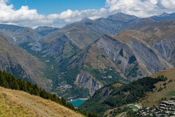 Hiking near ski station Les deux Alpes and view on Alpine mountains peaks in summer, Isere, France