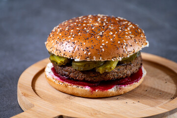 Lunch or dinner with tasty vegetarian hamburgers made from plant based grilled burgers, fresh bakes buns and organic vegetables
