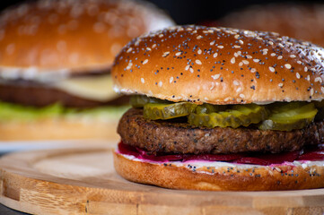 Lunch or dinner with tasty vegetarian hamburgers made from plant based grilled burgers, fresh bakes buns and organic vegetables