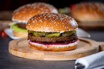 Lunch or dinner with tasty vegetarian hamburgers made from plant based grilled burgers, fresh bakes buns and organic vegetables
