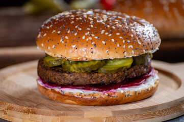 Lunch or dinner with tasty vegetarian hamburgers made from plant based grilled burgers, fresh bakes buns and organic vegetables