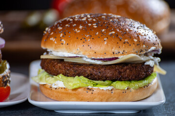 Lunch or dinner with tasty vegetarian hamburgers made from plant based grilled burgers, fresh bakes buns and organic vegetables