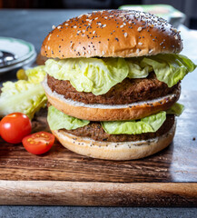 Lunch or dinner with tasty vegetarian hamburgers made from plant based grilled burgers, fresh bakes buns and organic vegetables