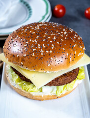 Lunch or dinner with tasty vegetarian hamburgers made from plant based grilled burgers, fresh bakes buns and organic vegetables