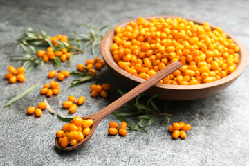 Fresh ripe sea buckthorn on grey table