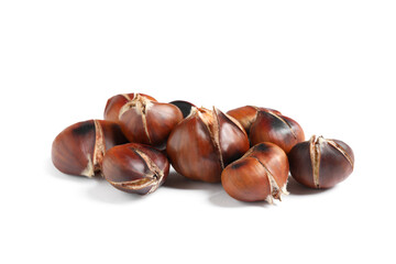 Delicious sweet roasted edible chestnuts isolated on white