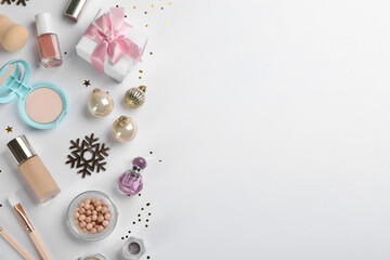 Flat lay composition with decorative cosmetic products on light background. Winter care. Space for text