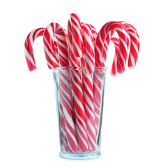 Glass with sweet Christmas candy canes on white background
