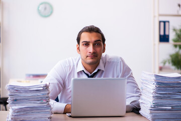 Young male employee unhappy with excessive work