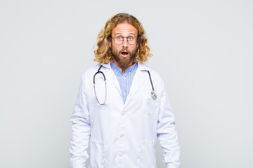 blonde man looking very shocked or surprised, staring with open mouth saying wow