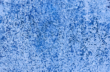 Fototapeta na wymiar The texture of a shabby wall with blue paint.