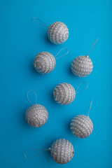 Christmas or New Year composition. Decorations, silver balls, on a blue background. Top view, copy space.