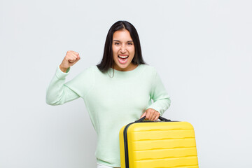 pretty woman feeling shocked, excited and happy, laughing and celebrating success, saying wow!