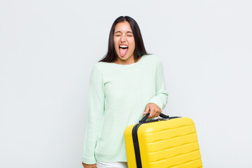 pretty woman with cheerful, carefree, rebellious attitude, joking and sticking tongue out, having...