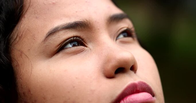 Hispanic young woman face looking up to sky with HOPE and FAITH