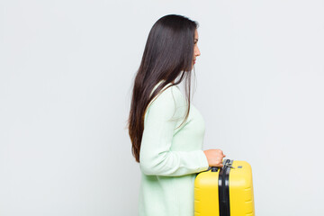 pretty woman on profile view looking to copy space ahead, thinking, imagining or daydreaming