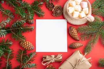 Christmas or New Year frame composition. Decorations, cones, fir and spruce branches, cup of coffee, on a red background. Top view, copy space.