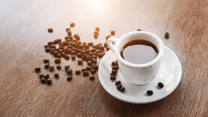 Coffee cup and saucer on a wooden table. Dark background.