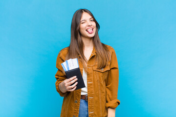 pretty woman with cheerful, carefree, rebellious attitude, joking and sticking tongue out, having...