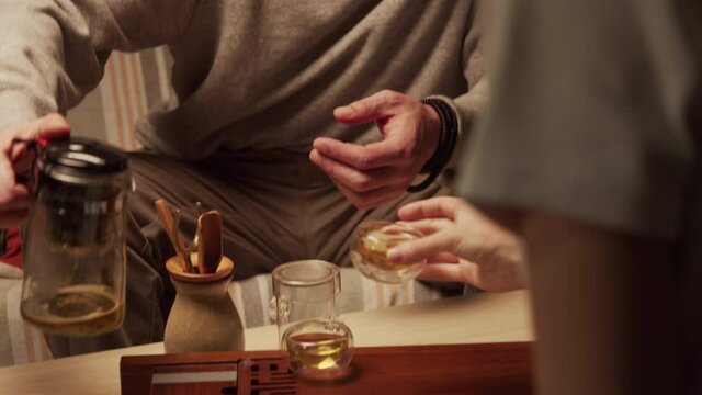 Two friends enjoy natural Chinese tea at a home tea ceremony and communicate with each other in a special room.