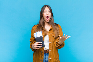 pretty woman feeling extremely shocked and surprised, anxious and panicking, with a stressed and...