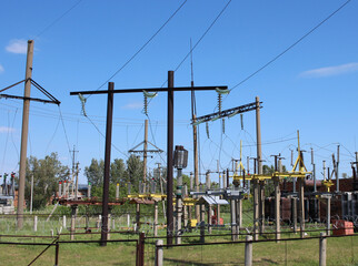 electric wires at a power plant on poles high-voltage voltage in a transformer