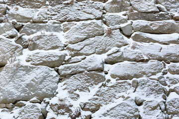 Snow covered rock wall in winter
