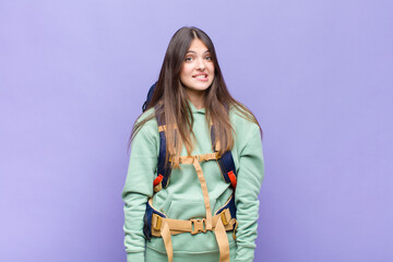 pretty woman looking puzzled and confused, biting lip with a nervous gesture, not knowing the...