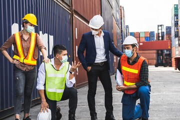 Workers waring surgical mask and safety white head to protect for pollution and virus in workplace during concern about covid pandemic