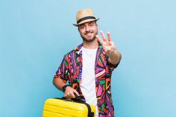 young man smiling and looking friendly, showing number one or first with hand forward, counting down