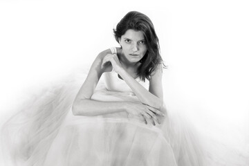 Young beautiful woman sitting in tulle dress monochrome portrait