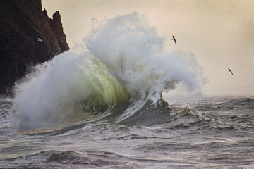 Stormy and powerful waves crash against the cliffs of Cape Disappointment