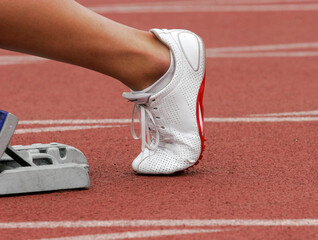 Runner stretching legs at starting blocks