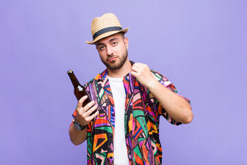young man looking arrogant, successful, positive and proud, pointing to self