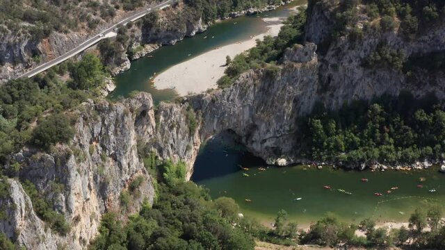 Aerial Shot of Pont D'Arc in Southern France, kayaks riding down the Ardeche river in south of france