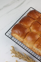 Roti Sobek or Pull Out Soft bread on black cooling rack. Isolated white background.