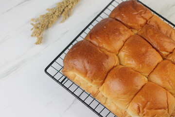 Roti Sobek or Pull Out Soft bread on black cooling rack. Isolated white background.