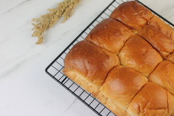 Roti Sobek or Pull Out Soft bread on black cooling rack. Isolated white background.