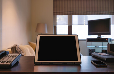 Digital tablet, blank black screen on working table 